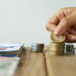 hand-holding-mexican-coin-930x620