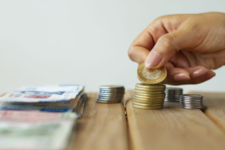 hand-holding-mexican-coin-930x620